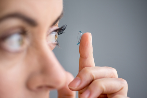 Women putting in a contact lens